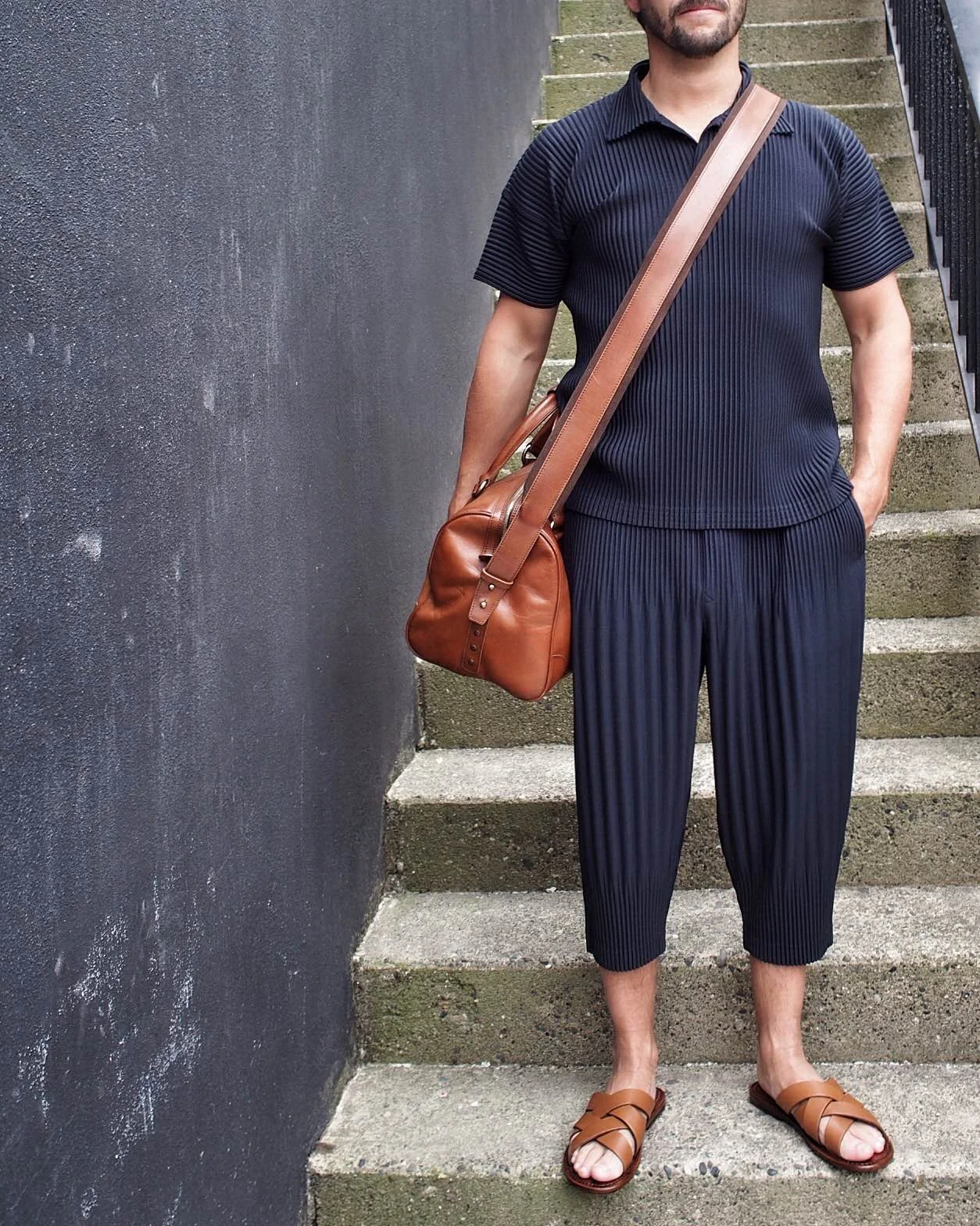 Homme Plisse cropped trousers and polo - with Maison Margiela bag and Pete Sorensen slides