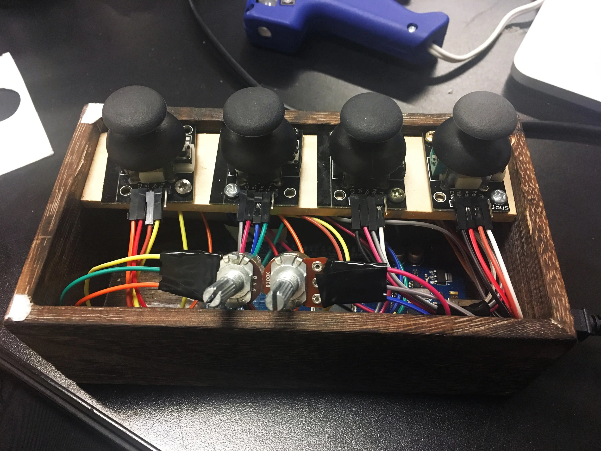 Controller box containing breadboard, Arduino, potentiometers, and joysticks 