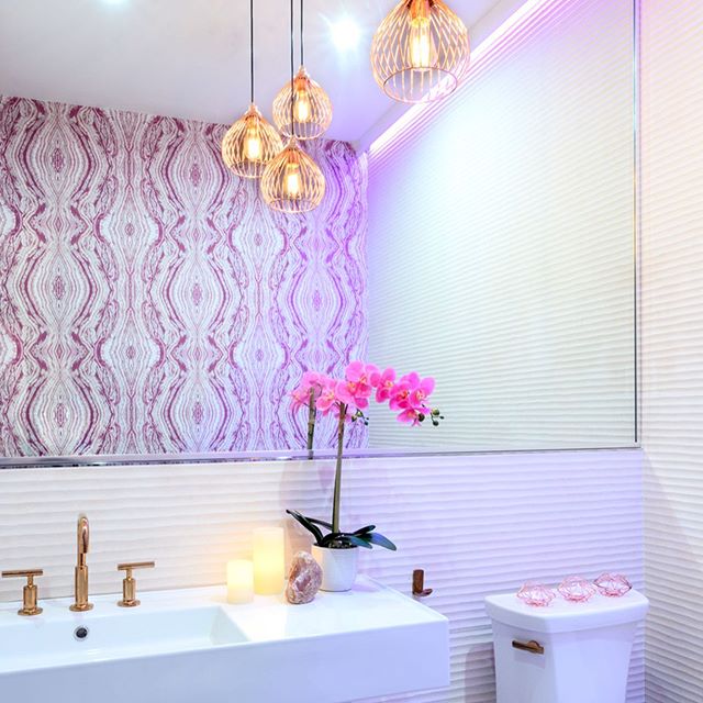 ...And let’s not forget the oh so important restroom, clientele can always tell a lot about a space by the detail and thought that’s put into the secondary spaces. The restrooms are one of our favorite places to get the most creative! We love to juxtapose very different textures, patterns and finishes; for example this gorgeous @eykondesign selenite #sourceonewallcovering that started it all, complimented by the beautifully textured @porcelanosa wall tile which we extended by reflecting in a large scale mirror and finished off with metallic rose gold @kohler purist line fixtures and a fun @elegantlighting multi-pendant. Photo cred: @haphotography.nyc #whybeordinary #restroomdesign #bathroomdesign #mixingmaterialsandpattern #prettywallpaper #texturaltiles #rosegoldfixtures