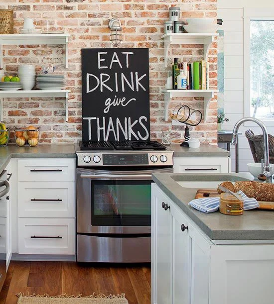 From Liz Marie Blog Using open shelving allows for more space to showcase the exposed brick. A small wall above cabinets can be a great space to test out the brick look.