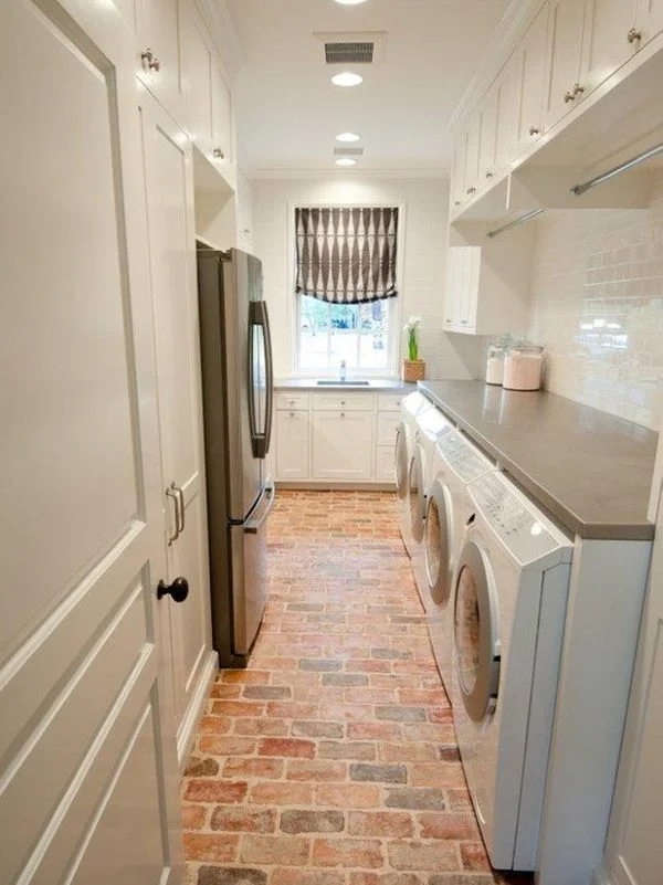 From homedit Exposed brick is also a great option for floors! These floors pop when paired with white cabinets in this gorgeous laundry room.