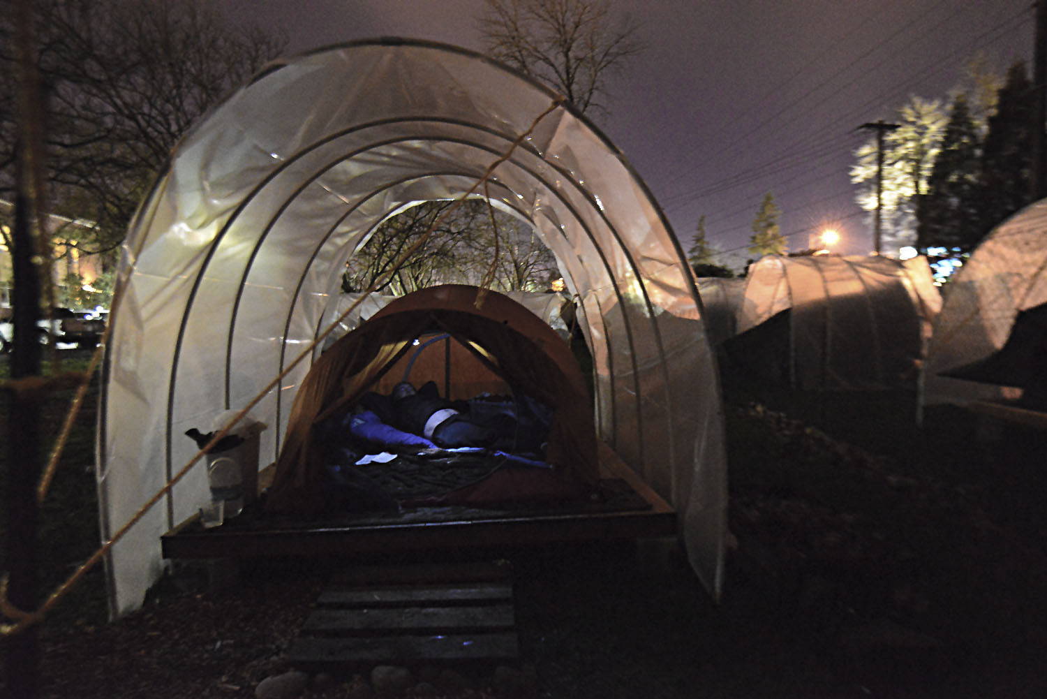 Eugene, Ore. - Ken rests comfortably in his conestega mobile housing. He as found permanent housing sincewhen this photo was taken in February 2015. By: Debra Josephson