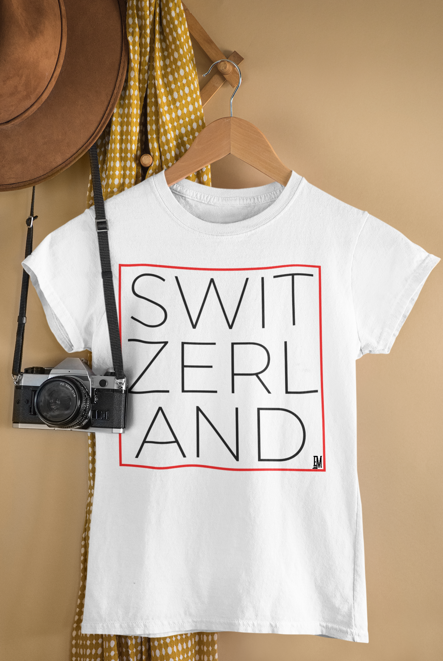 mockup-of-a-t-shirt-hanging-by-a-vintage-camera-33739.png