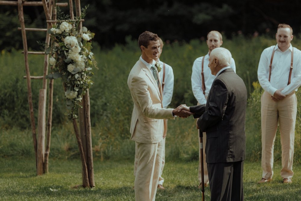 024_cameron-alexa-wedding-142_groom grandfather shake hands.jpg