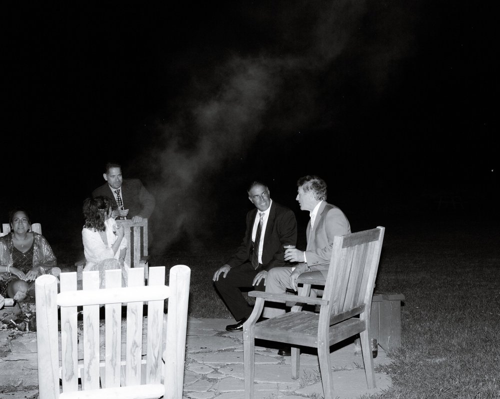 116_cameron-alexa-wedding-734_wedding fire pit men talking .jpg