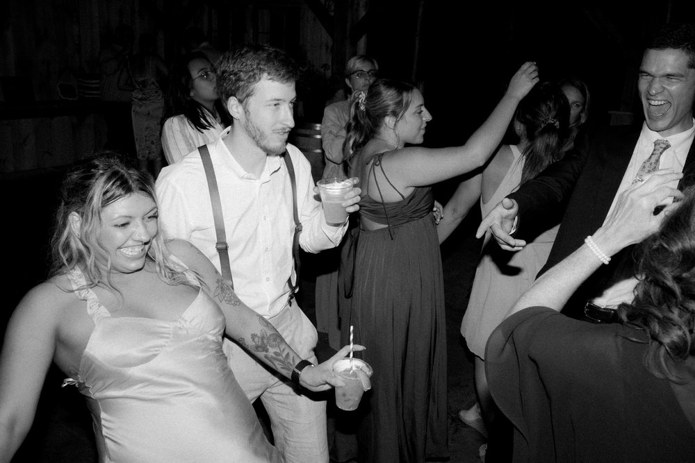 126_cameron-alexa-wedding-770_wedding guests dancing black and white .jpg