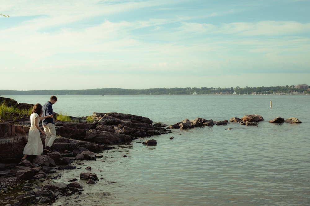 11_couple walking to the waterfront in the summer at oakledge beach burlington vermont .jpg