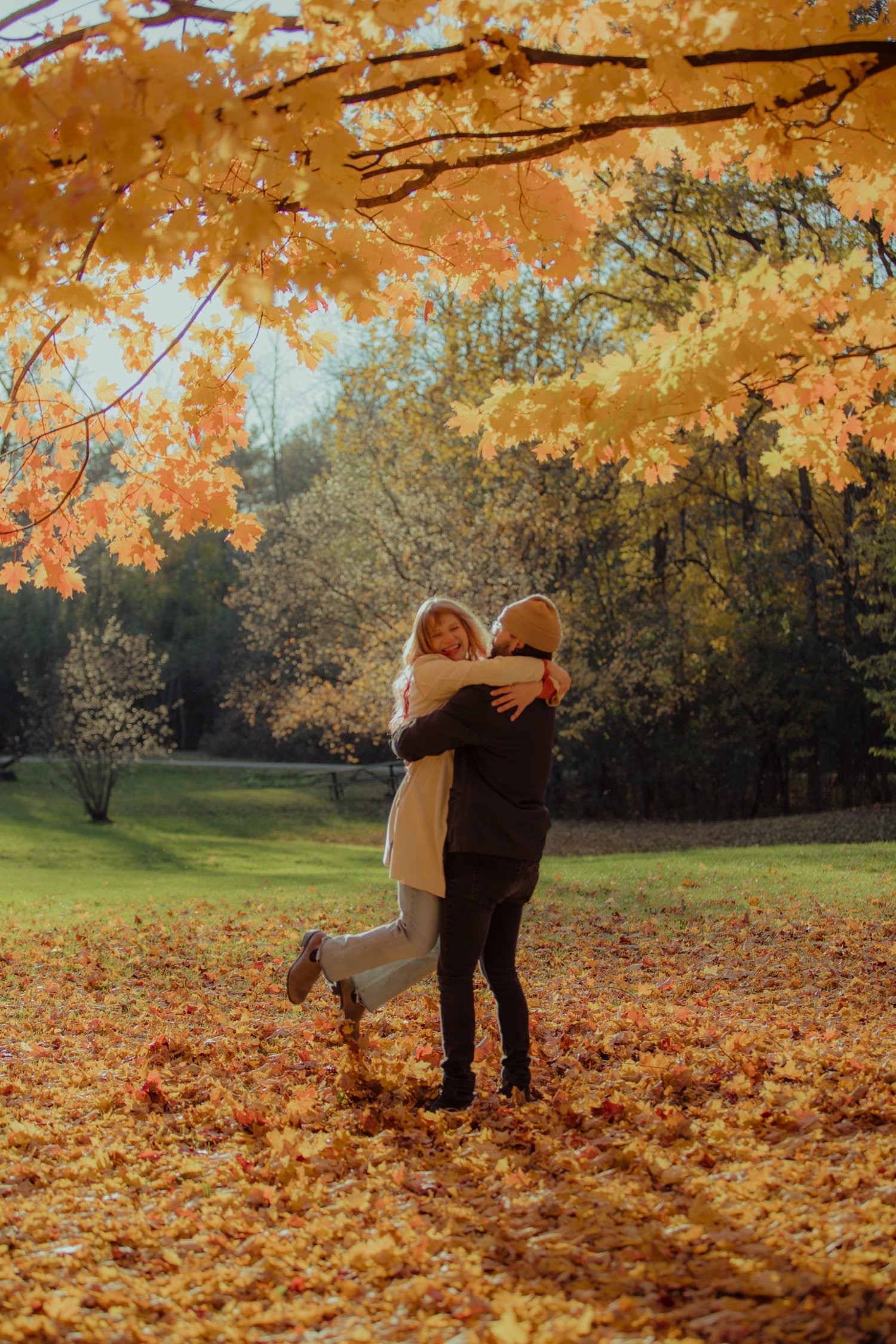 13_fun couple spinning in the fallen leaves at grand isle state park vermont .jpg