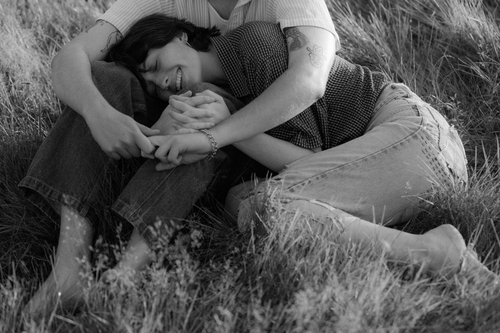 15_young couple cuddling in tall summer grass vermont .jpg