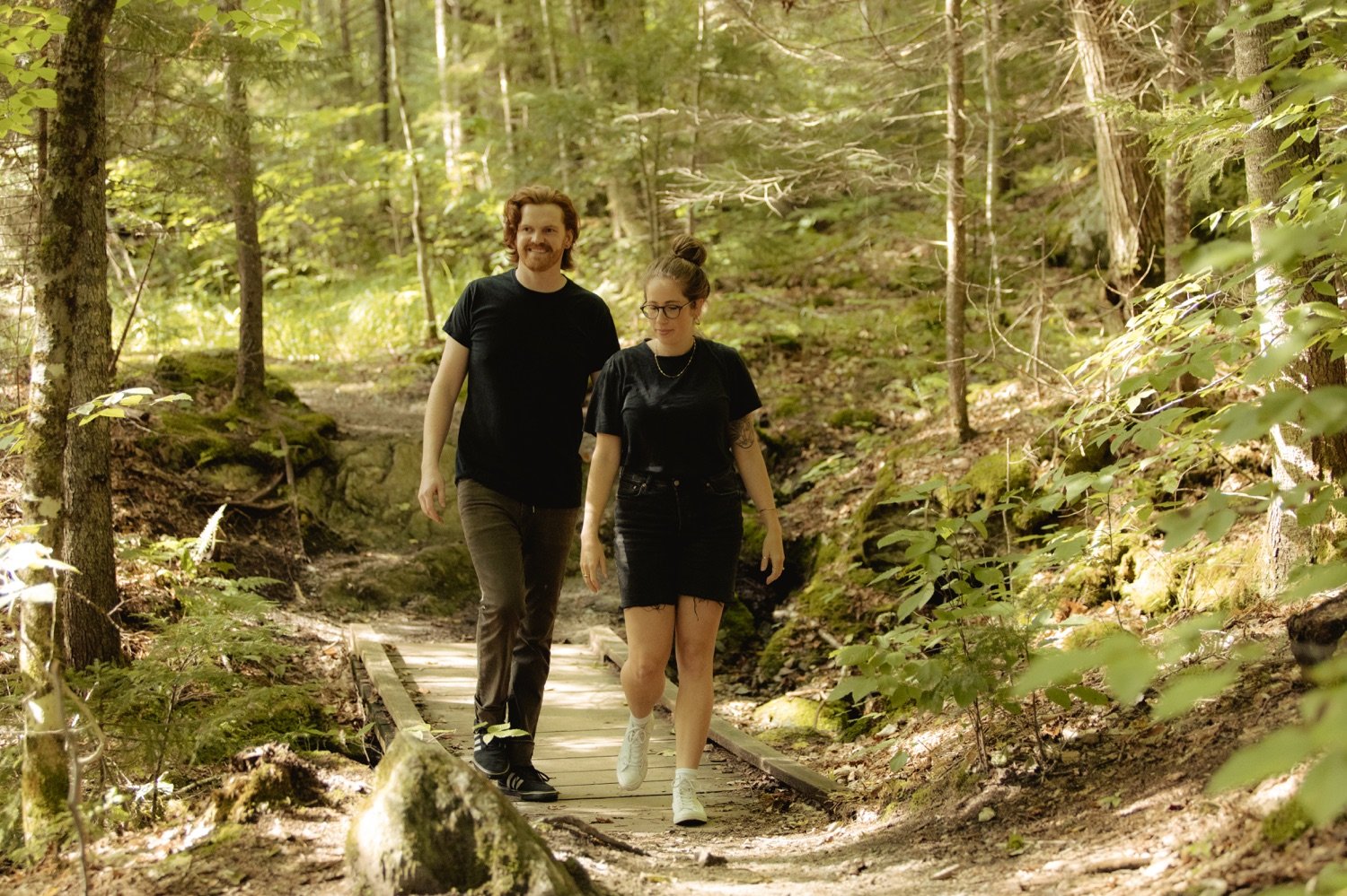 17_couple walking through wooded green mountain national forest texas falls hancock vermont .jpg