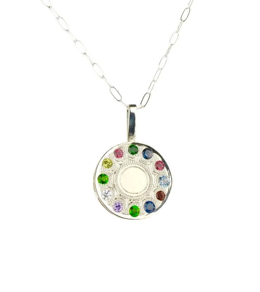 This past holiday, I was given the opportunity to make a grandmother's pendant. My client requested twelve birthstones laid out in a circle like numbers on a clock.  Here are the results! 

Hand made in sterling silver set with twelve birthstones, an