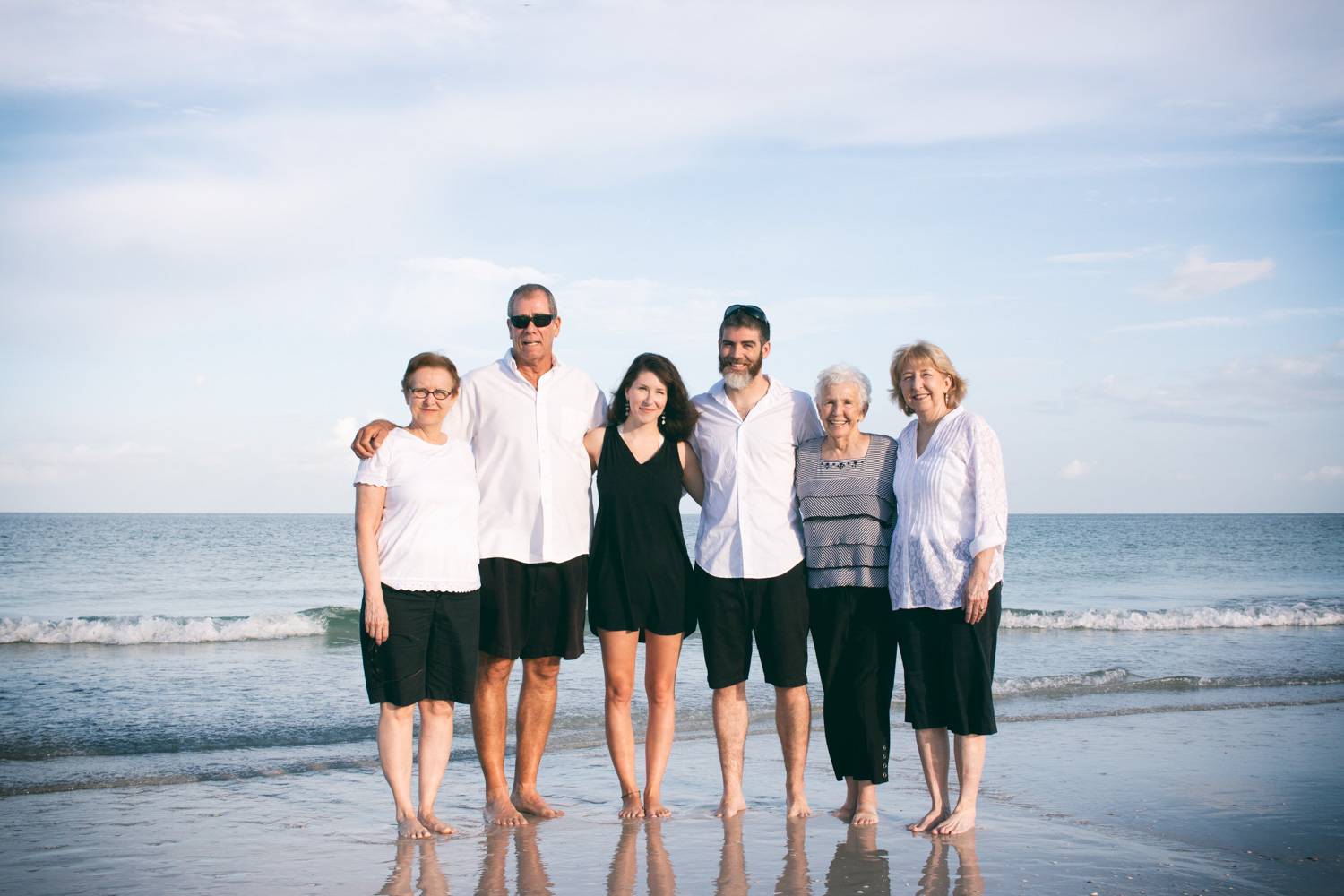 The family poses along the shore at Pass-a-Grille Beach.
