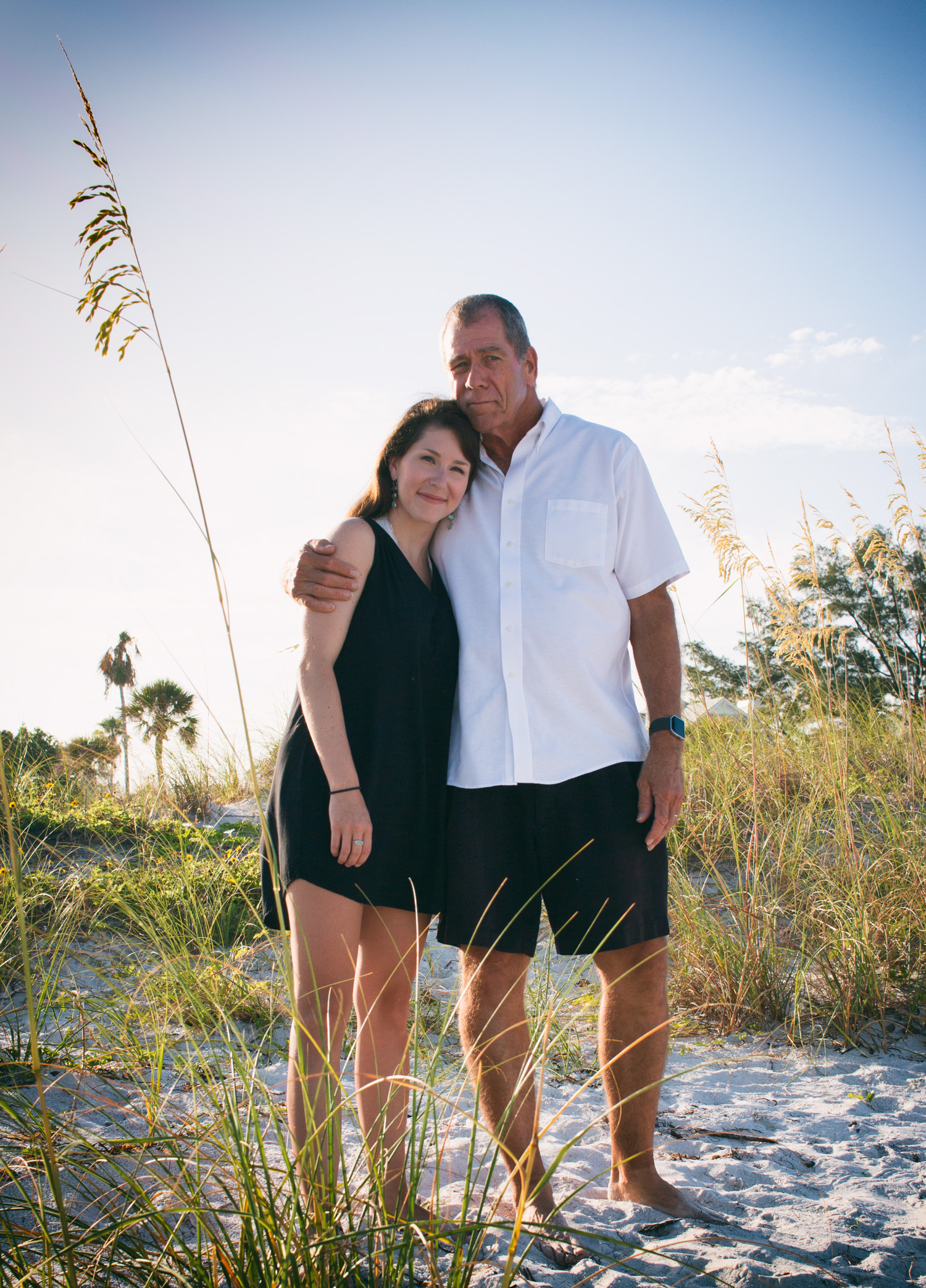 A sweet father and daughter photo amongst the sand and long grass at Pass-a-Grille Beach.