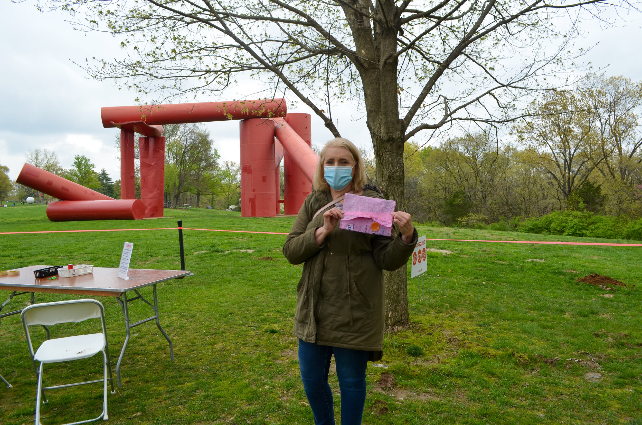  Woman holding finished fused plastic pouch that she created 