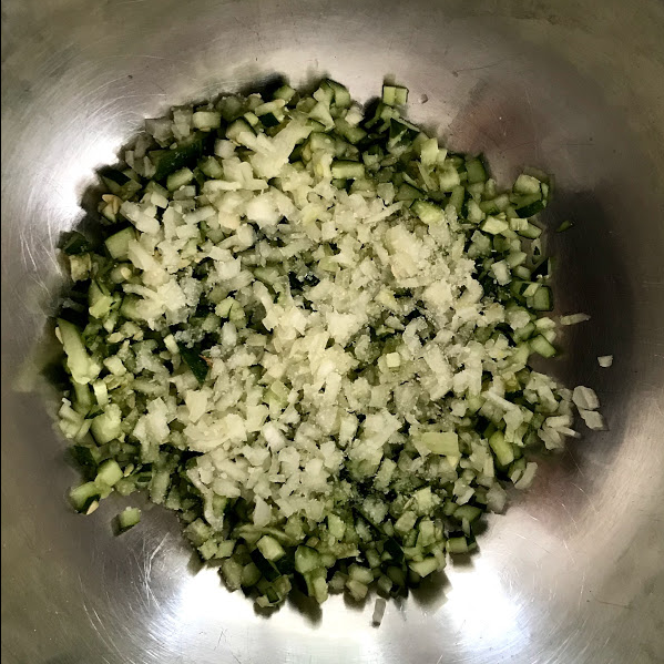 CUCUMBER, ONION, AND SALT LAYERED IN BOWL