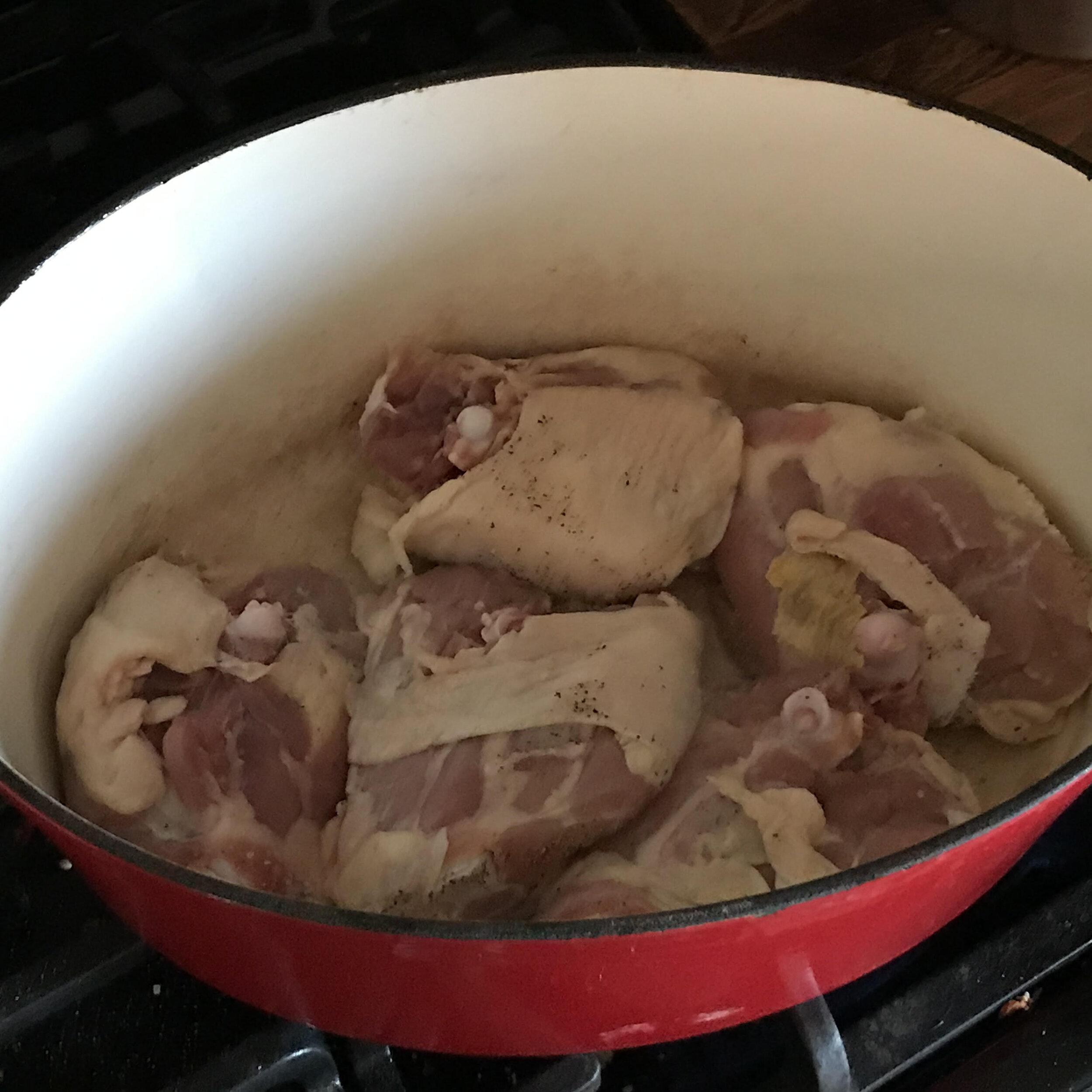 10. Place chicken skin-side down in hot Dutch oven.