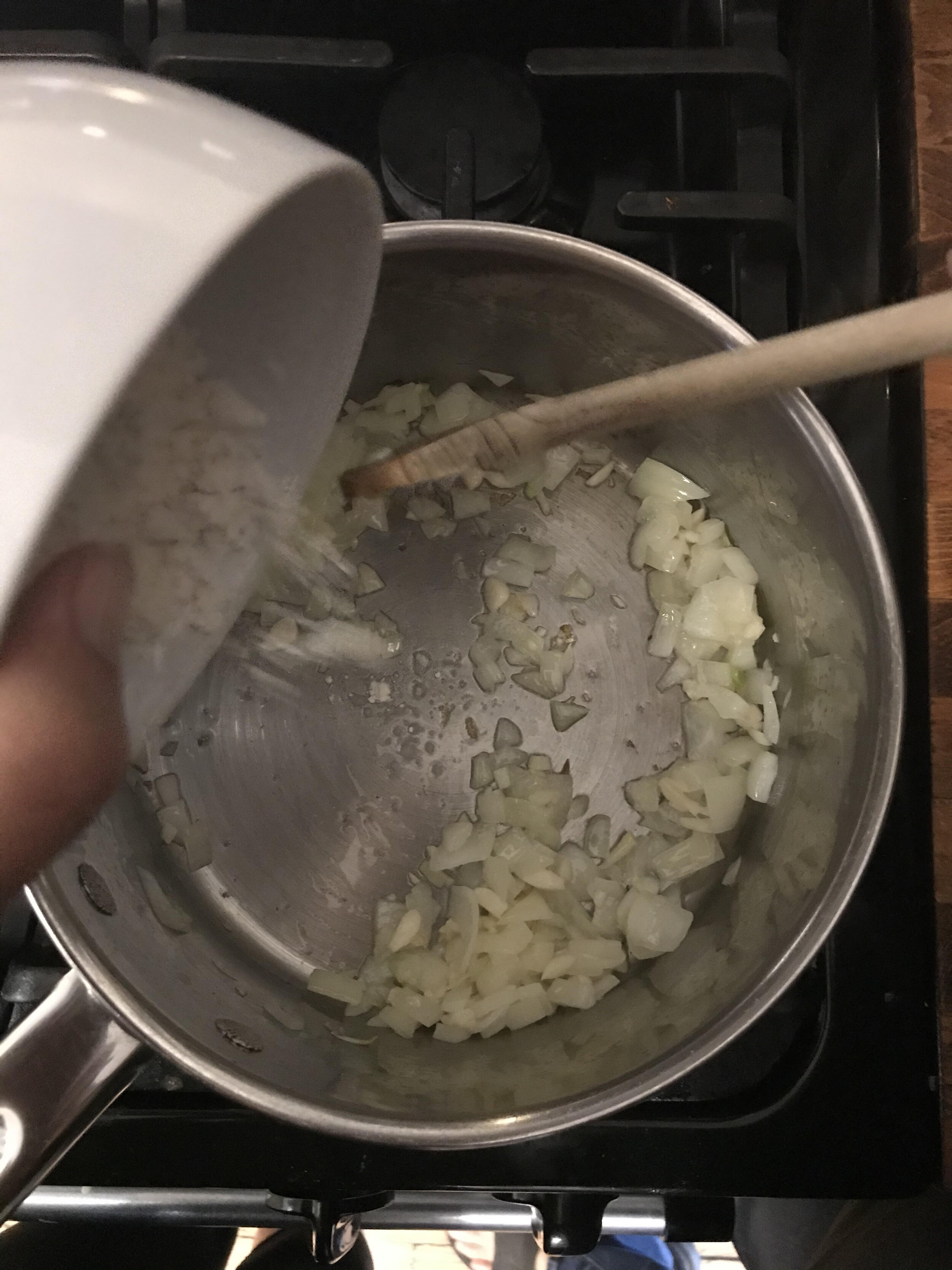 Add the flour to the onions and garlic.