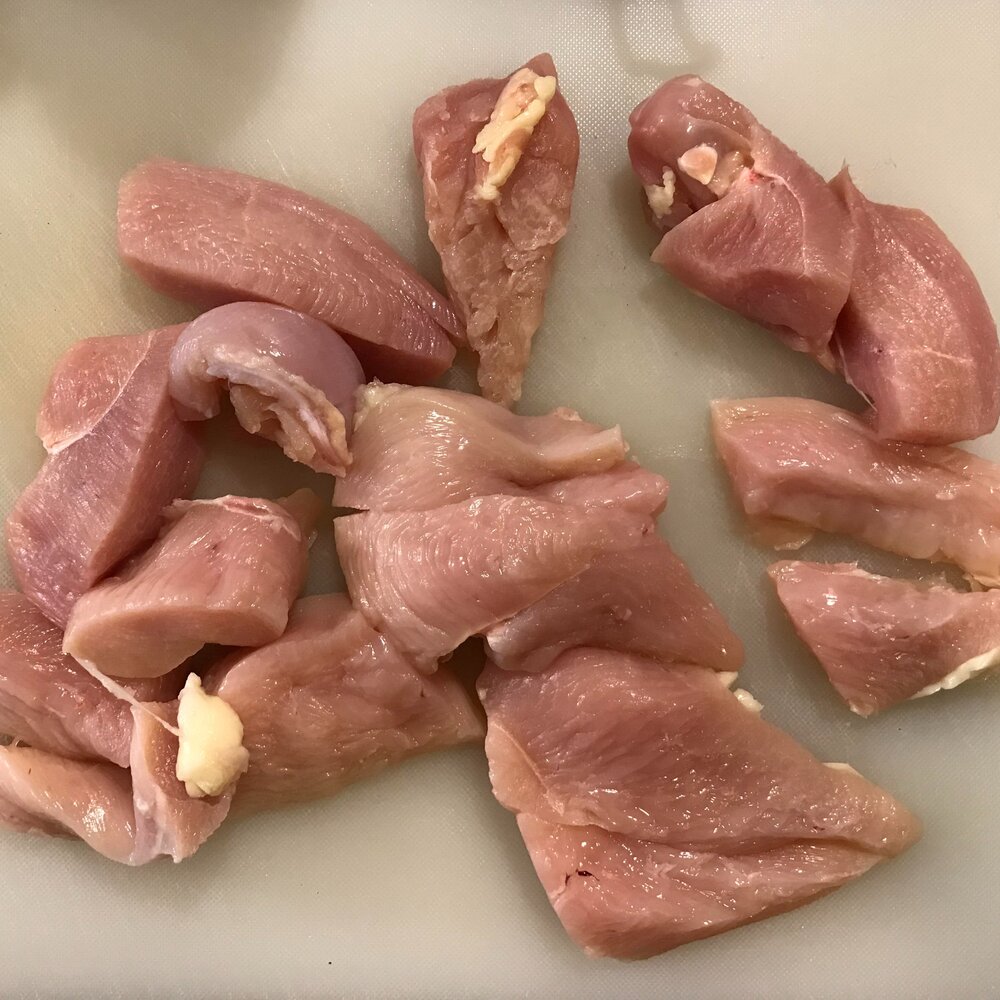 Cut chicken breasts in half and then into quarters.