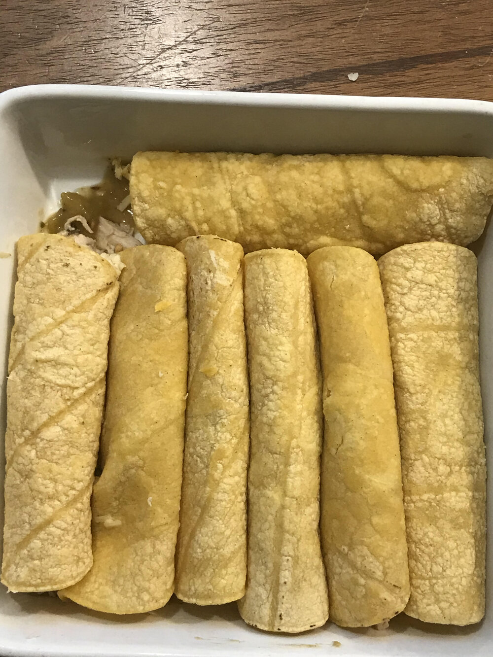 Pack the rolled tortillas snuggly into the baking dish.