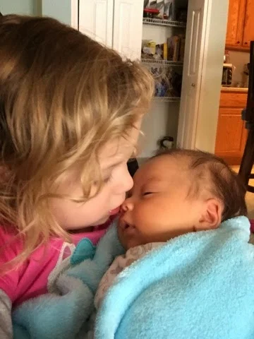 She loves giving her baby Justus kisses on his nose. 