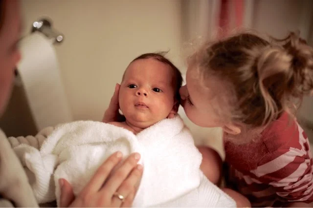 Bath time with mommy...and who wouldn't want a smooch from this little girl?