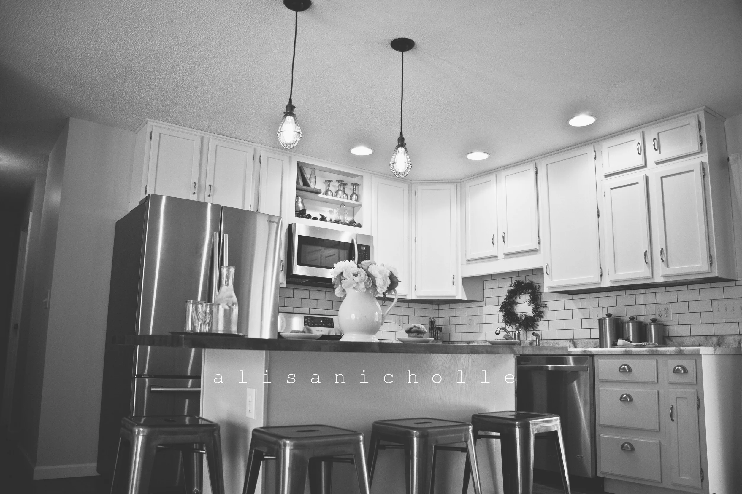 We removed all those terrible old light fixtures that made absolutely no sense and added recessed lighting and 2 pendant lights for more natural looking light.