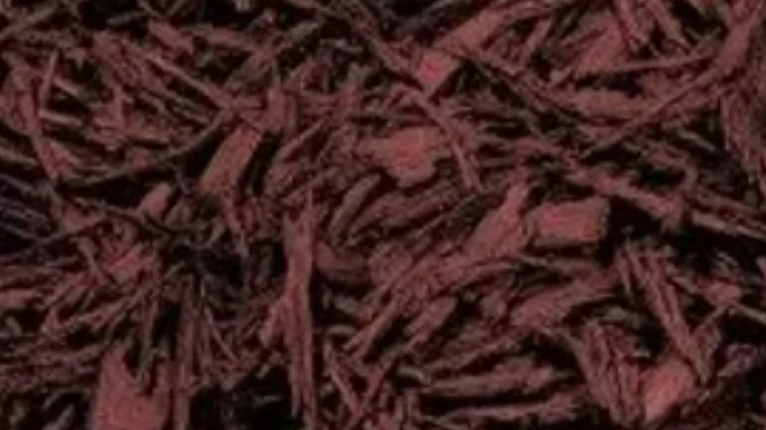 Close-up of shredded brown paper or bark with a textured surface.