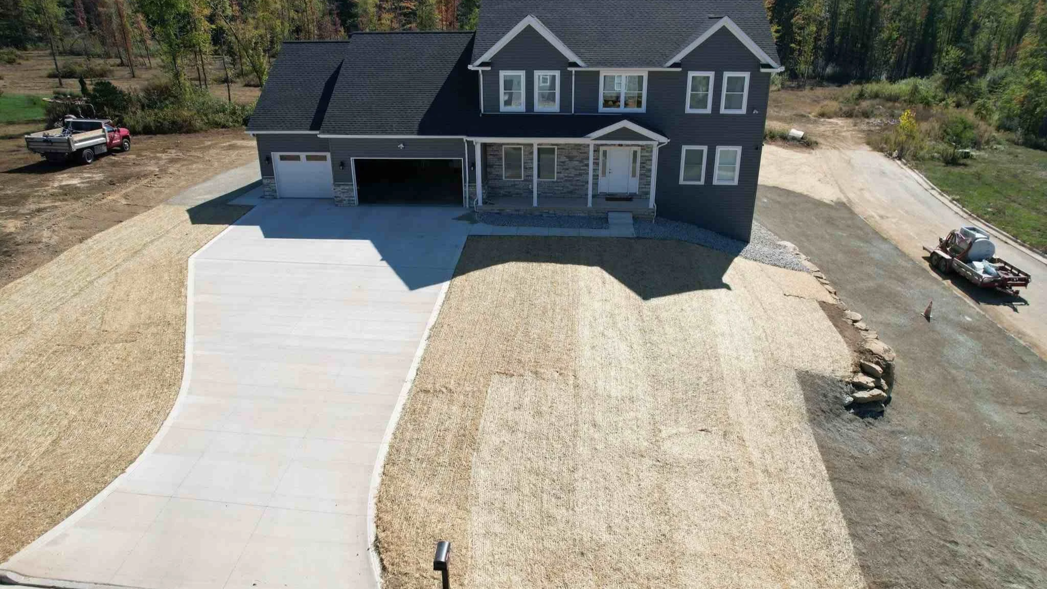 Drone view of a two-story house with new lawn being installed