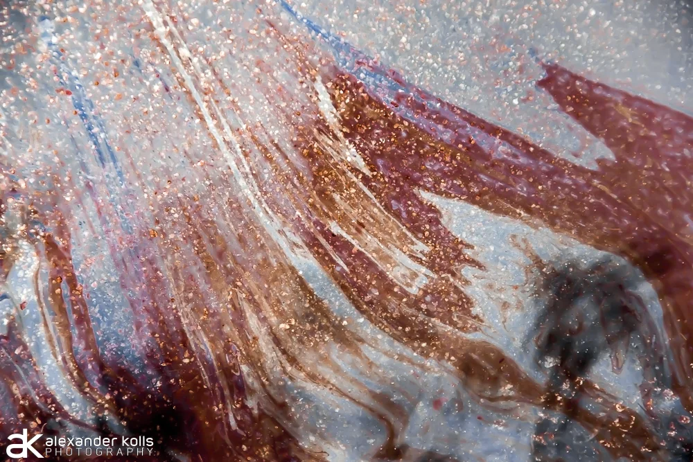 Ripple 2 / trippy fine art macro photography by photographer Alexander Kolls was created to serve as a visual study of thin film interference patterns. These patterns in puddles appear as nebula, and evokes a sense of cosmic scale. They're hypnotic,