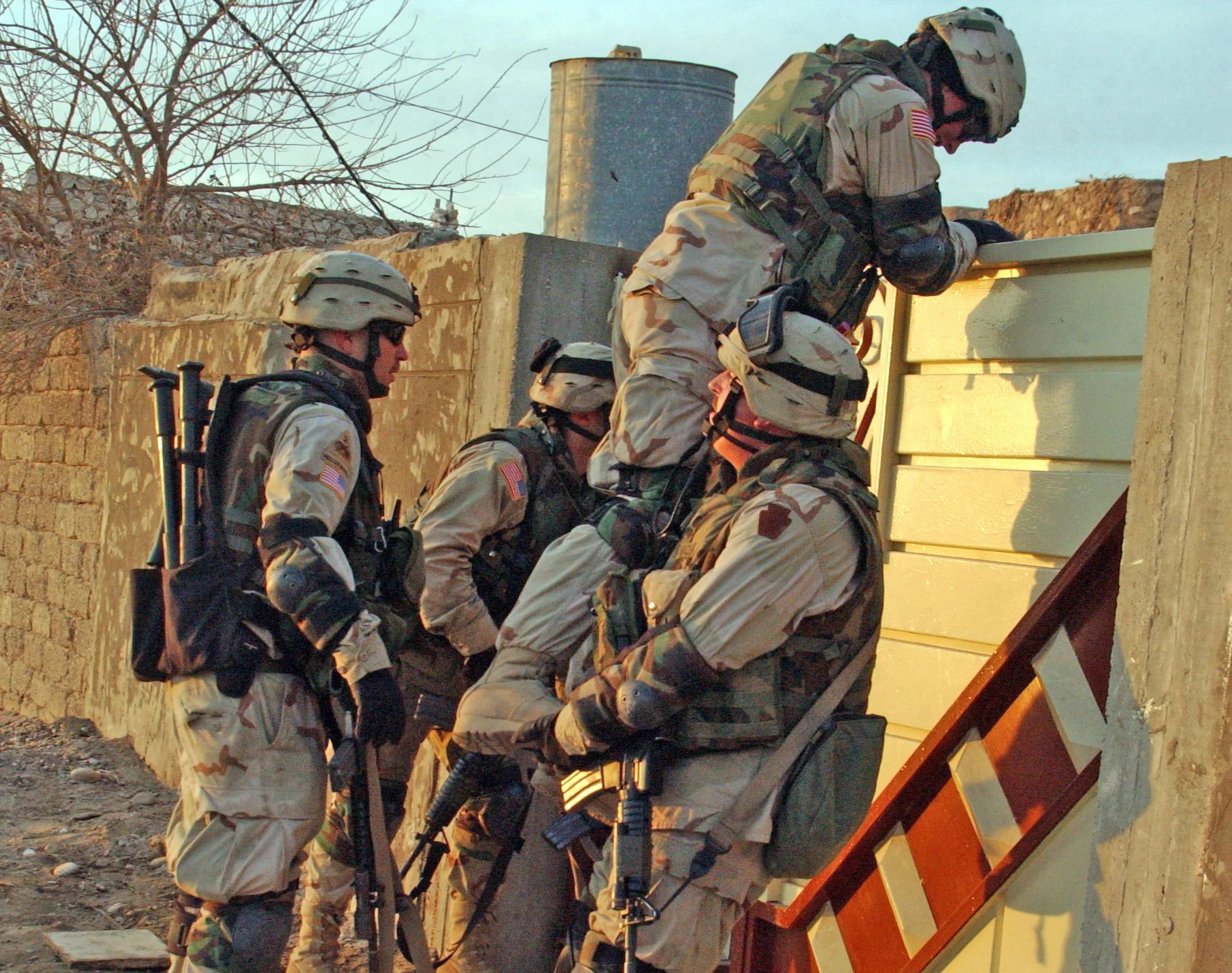 Spc. Shalllenberg gets a boost from a fellow Soldier