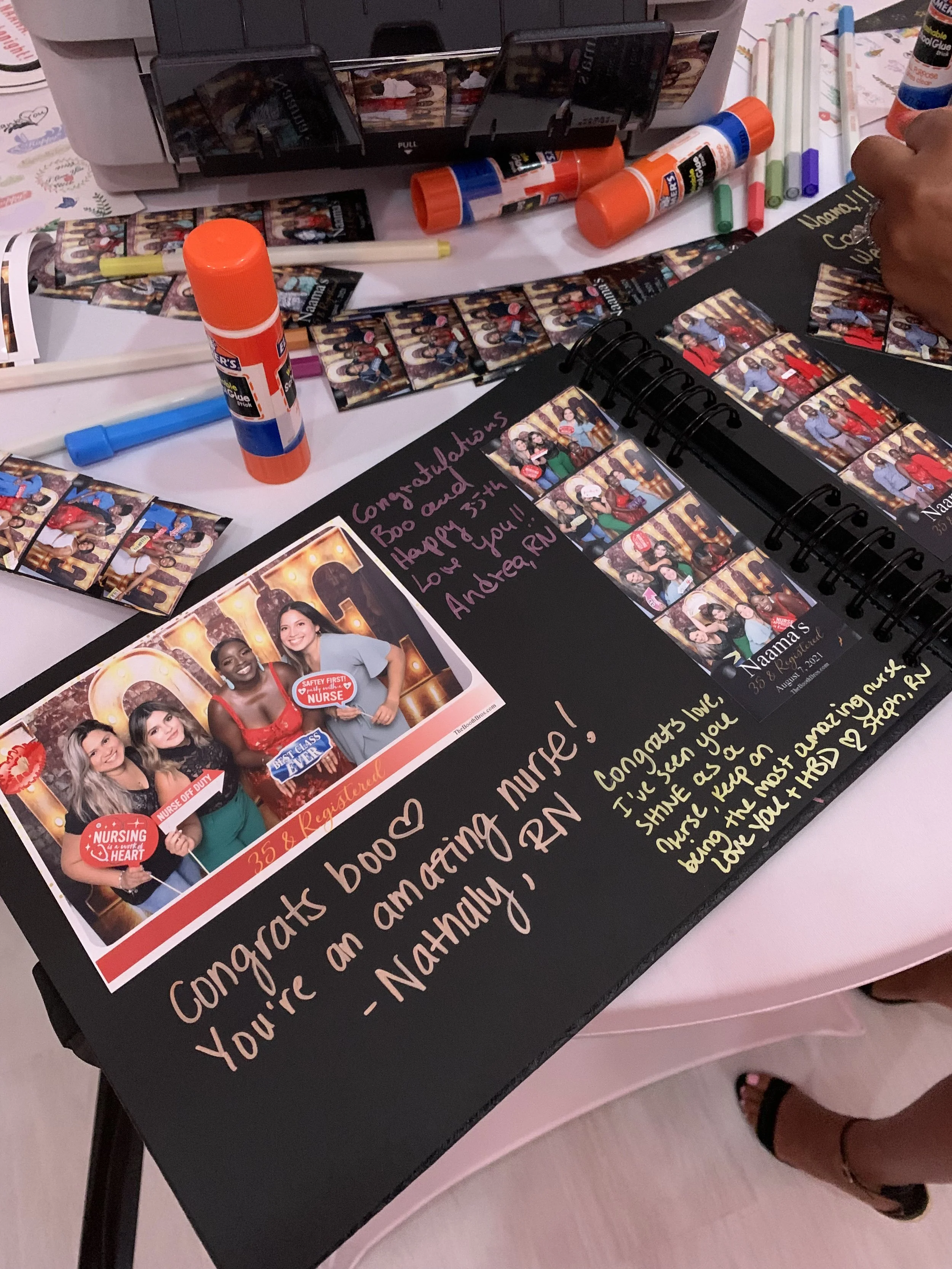 A scrapbook on a table of the photos from a Photo Booth experience.