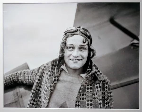 "Stunt pilot Dorothy Hester was probably around age nineteen when she posed next to a plan for this photograph. Hester, from Milwaukie, Oregon, learned to fly at the Rankin School of Flying in Portland. She impressed Tex Rankin, and he taught her aerobatics. In June 1930, at age nineteen, she became the first woman to perform a stunt called an outside loop. Hester wowed audiences both in Oregon and at air shows around the nation, set world records for stunt flying, and opened her own flight school. She left her career in aviation after marrying in 1934." 
