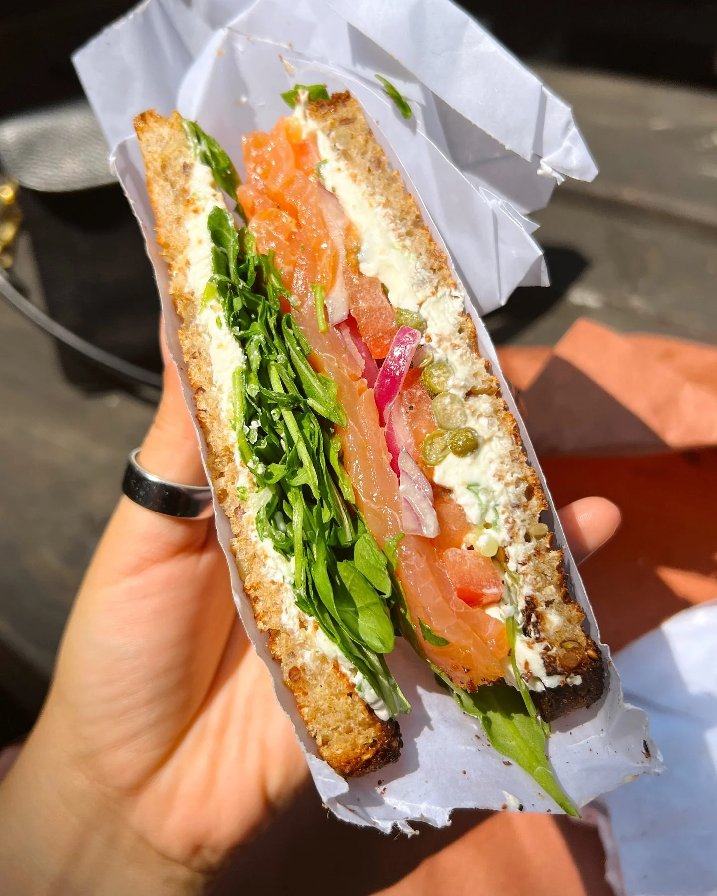 Take a bite out of our #6 Smoked Salmon sandwich! It comes with chive cream cheese, juicy tomato, capers, crunchy red onion &amp; arugula all on toasted multigrain bread. 🥪 

#williamsburg #nyceats #williamsburgfoodie #nycfoodie #williamsburgbrookly