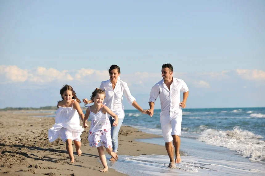 happy young family in white clothing have fun at vacations on beautiful beach.jpeg
