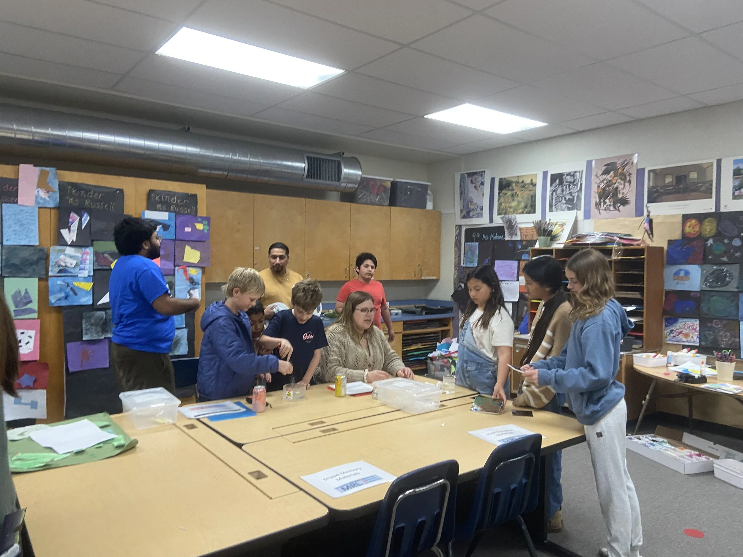 Two members of the group, Gabrielle and Anush, are teaching elementary school students about stimuli-responsive materials.