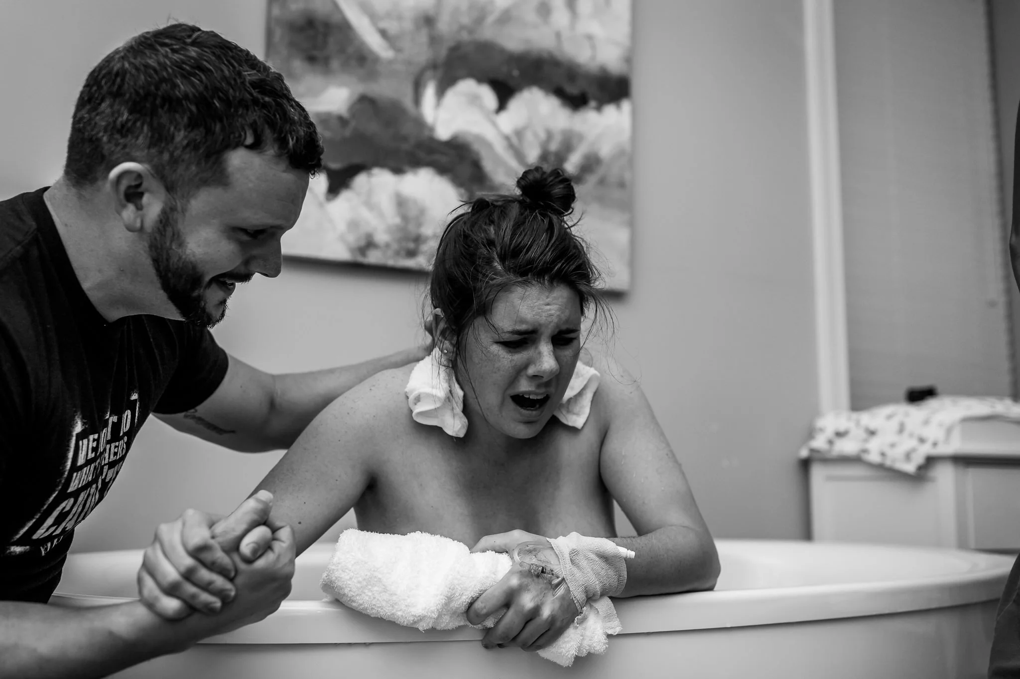 dad encouraging mom through birth contraction