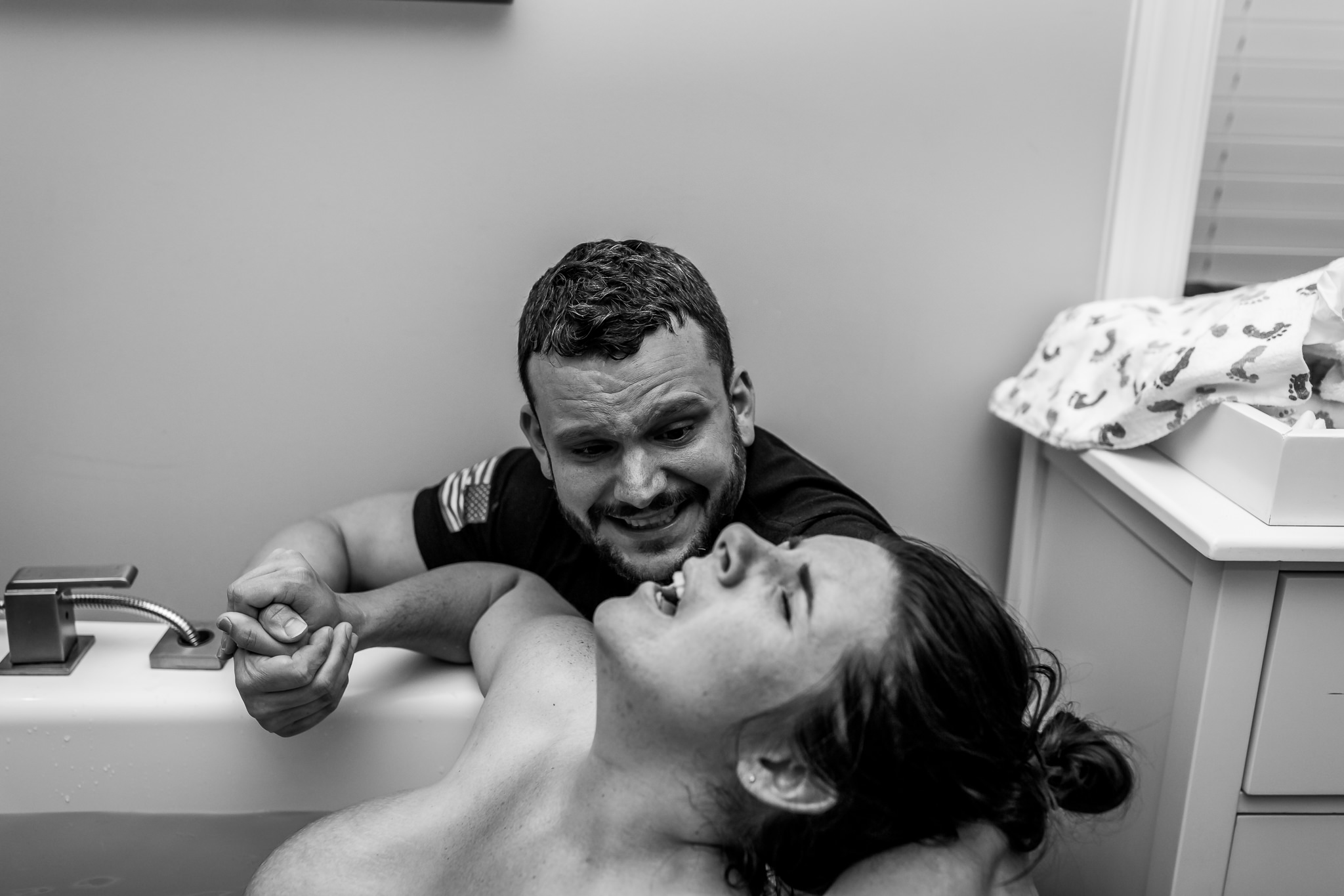 dad emotional as wife labors during water birth