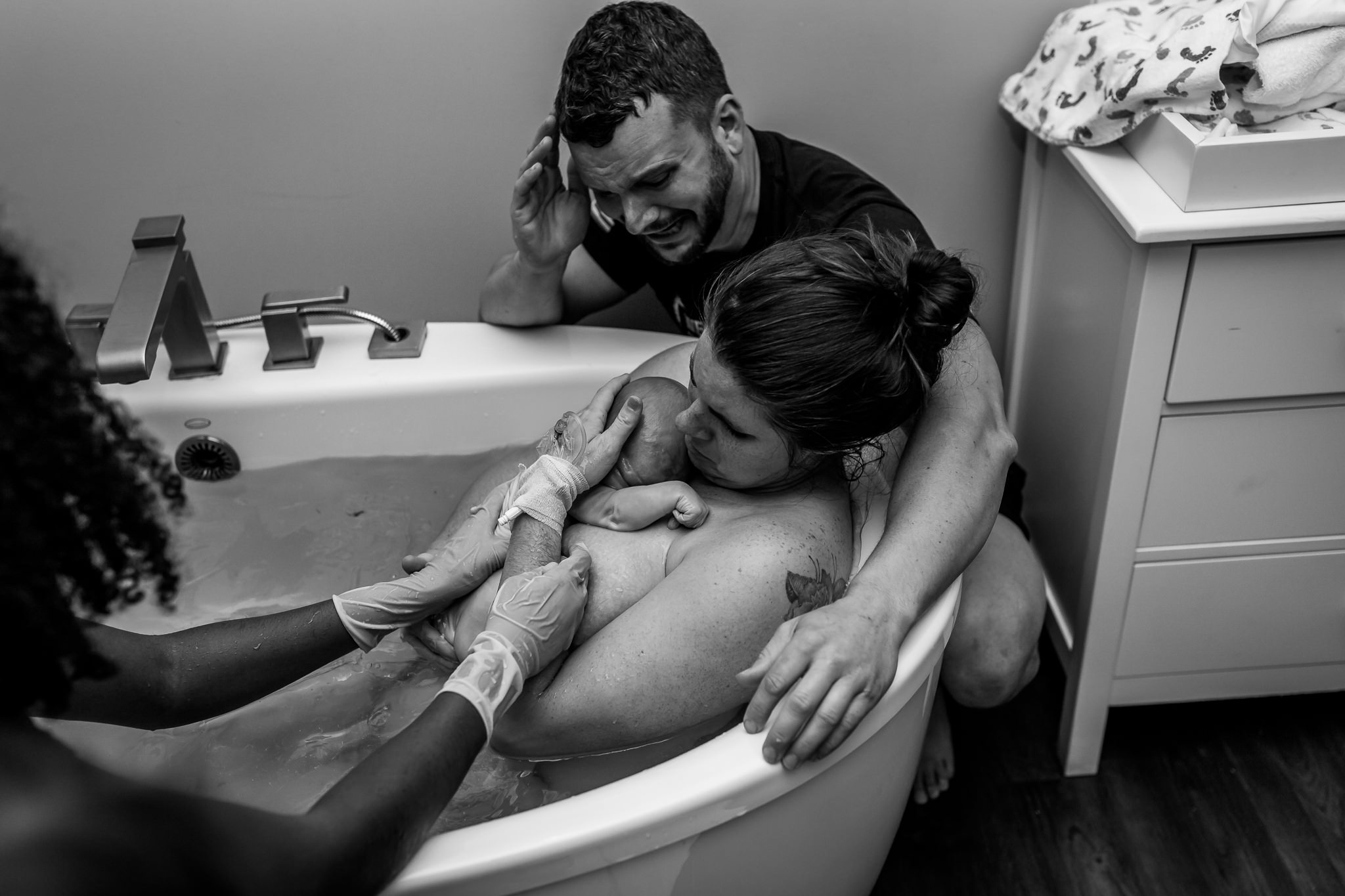 dad emotional at the water birth of his son