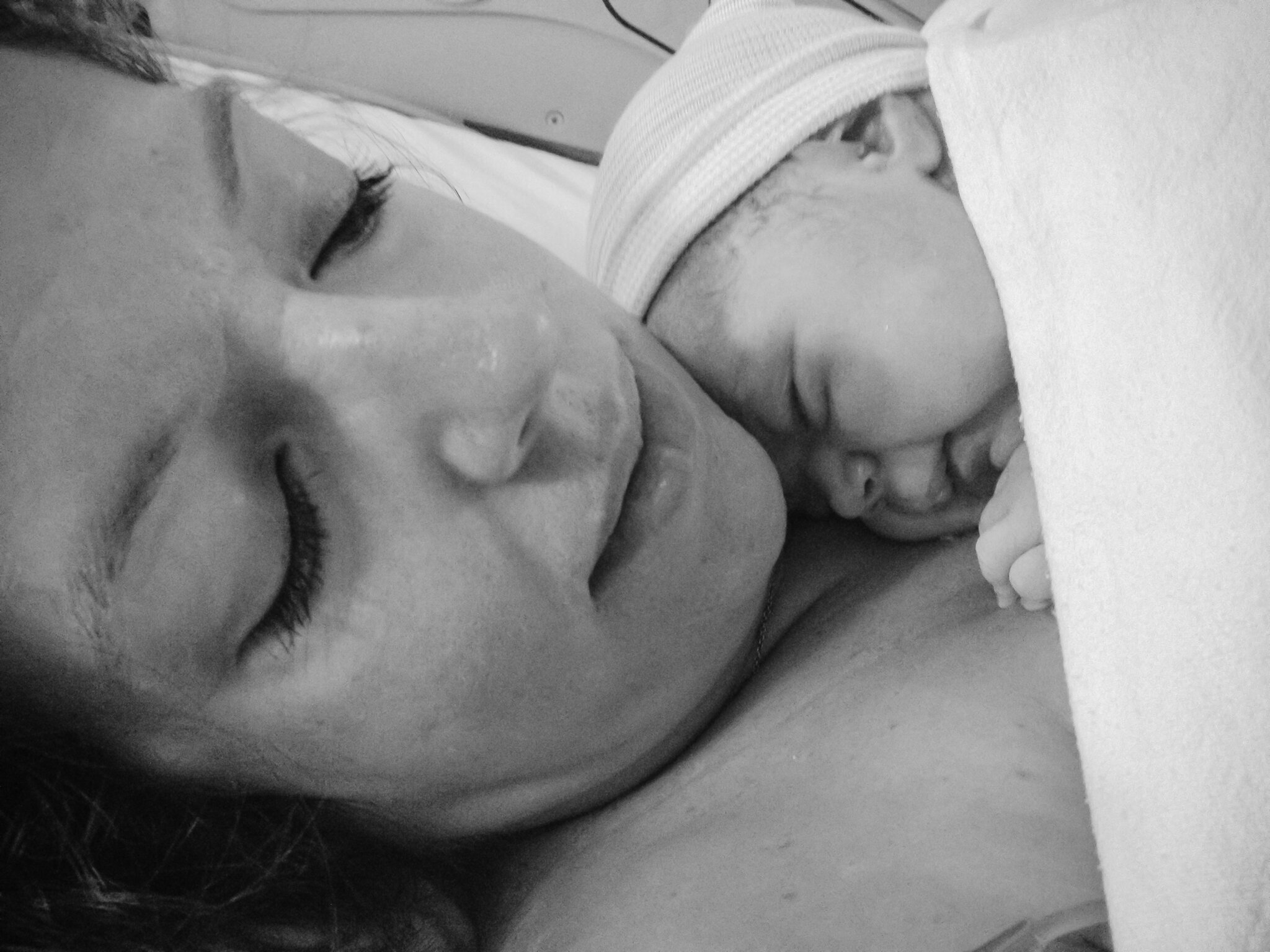 close up of mom with newborn infant on her chest after birth