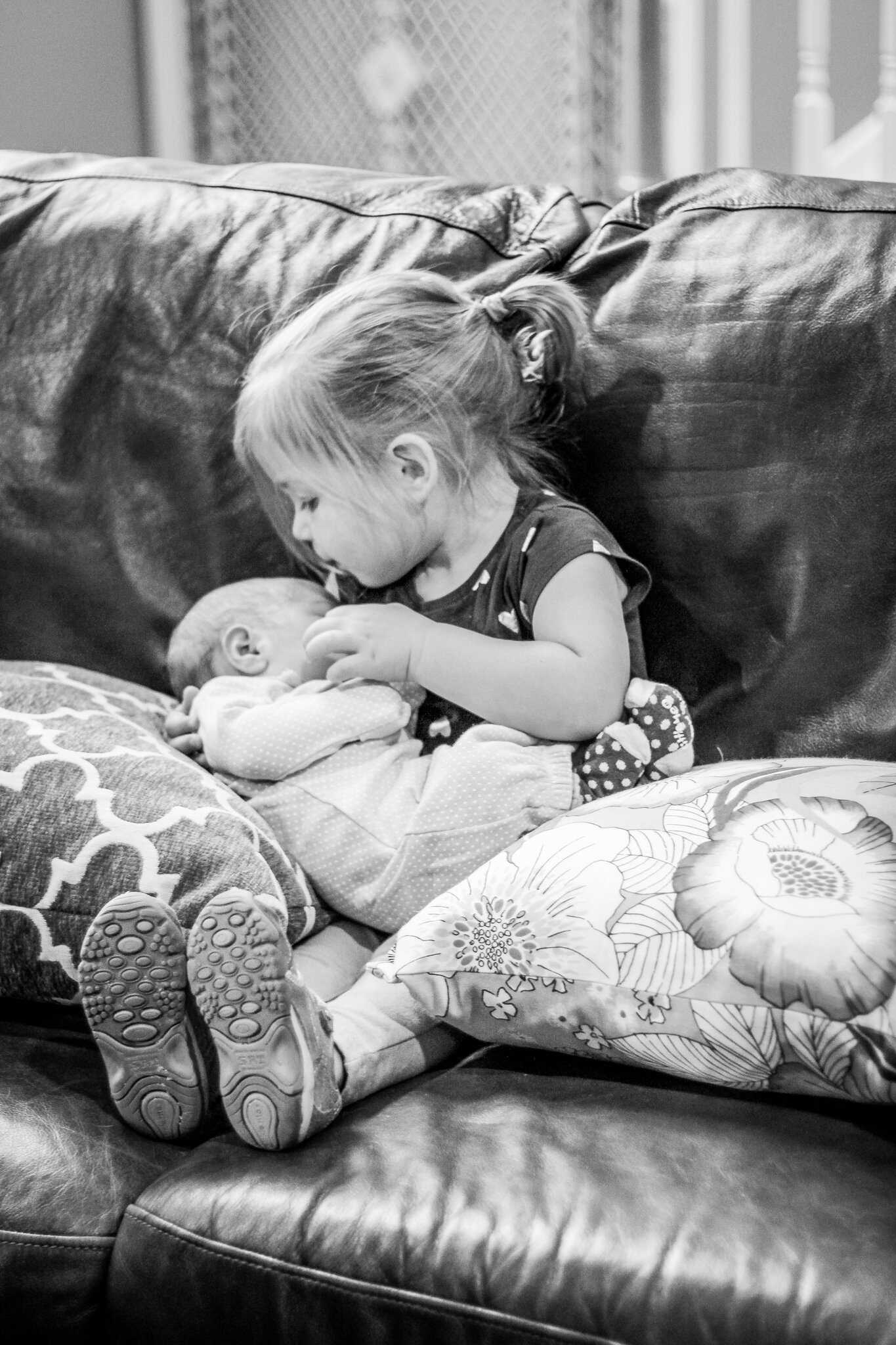 little girl holding newborn sibling
