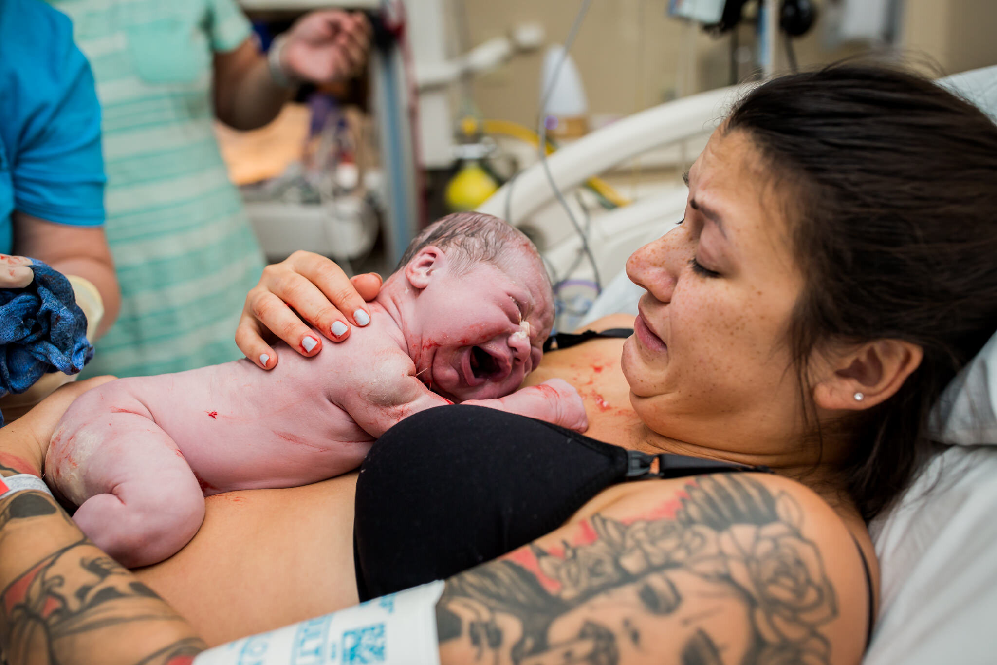 mom holds baby on her chest after birth