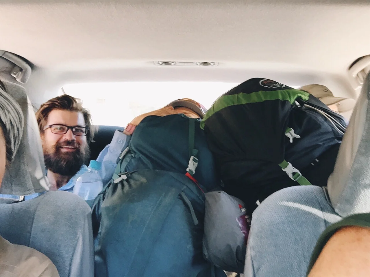 They all squished into the back of the car. 