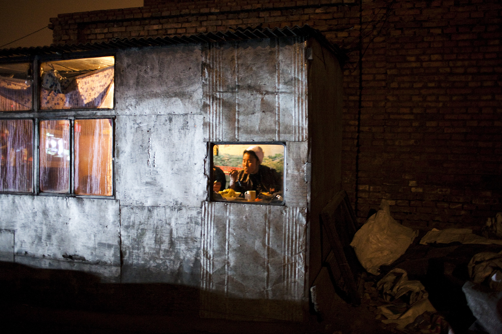 A coal yard boss eats inside her home.