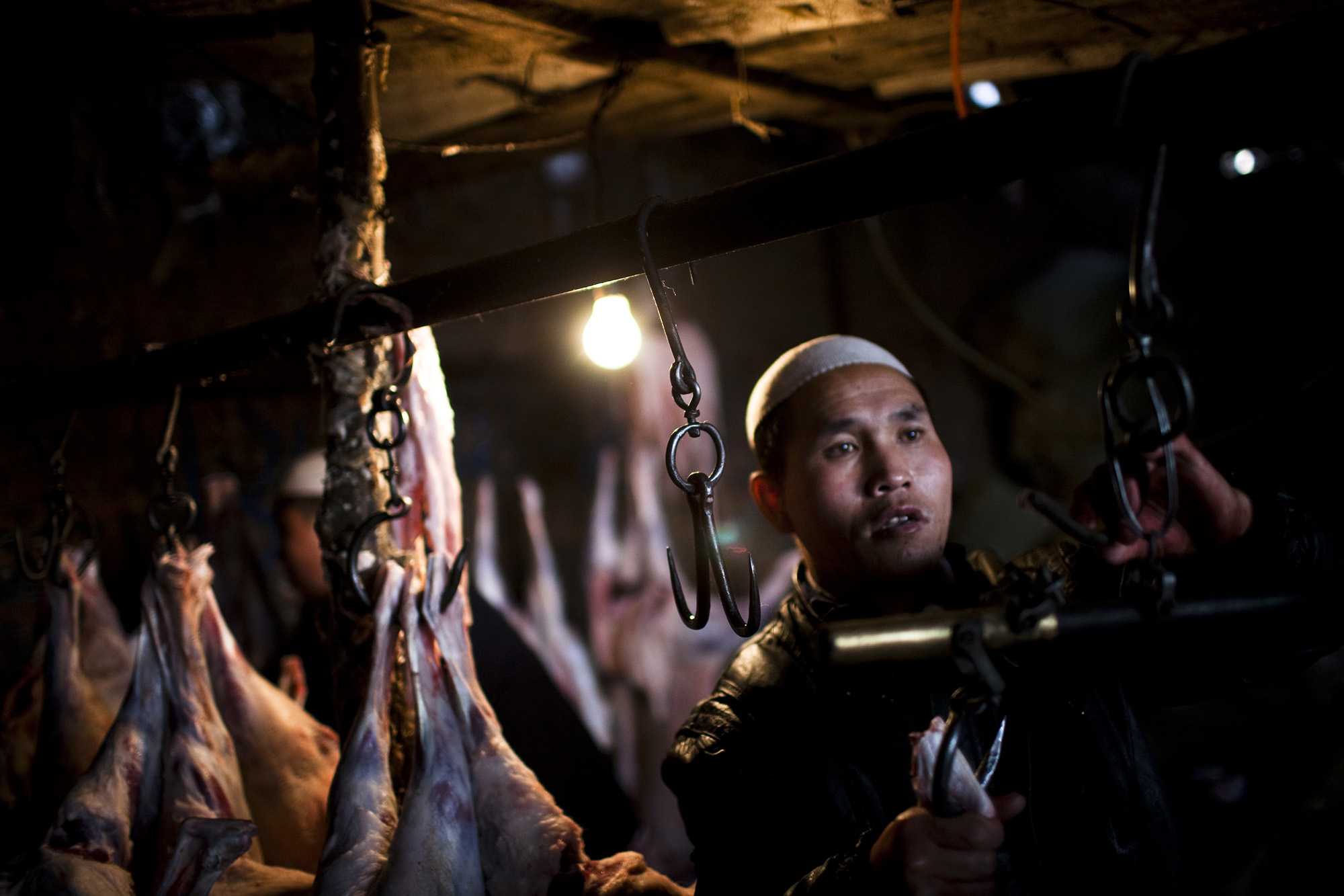Weighing up mutton in a slaughterhouse.