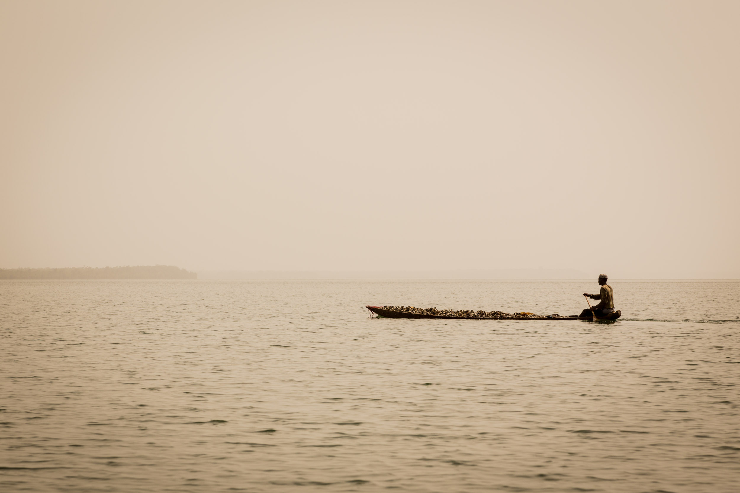 Guy with oysters in harbour