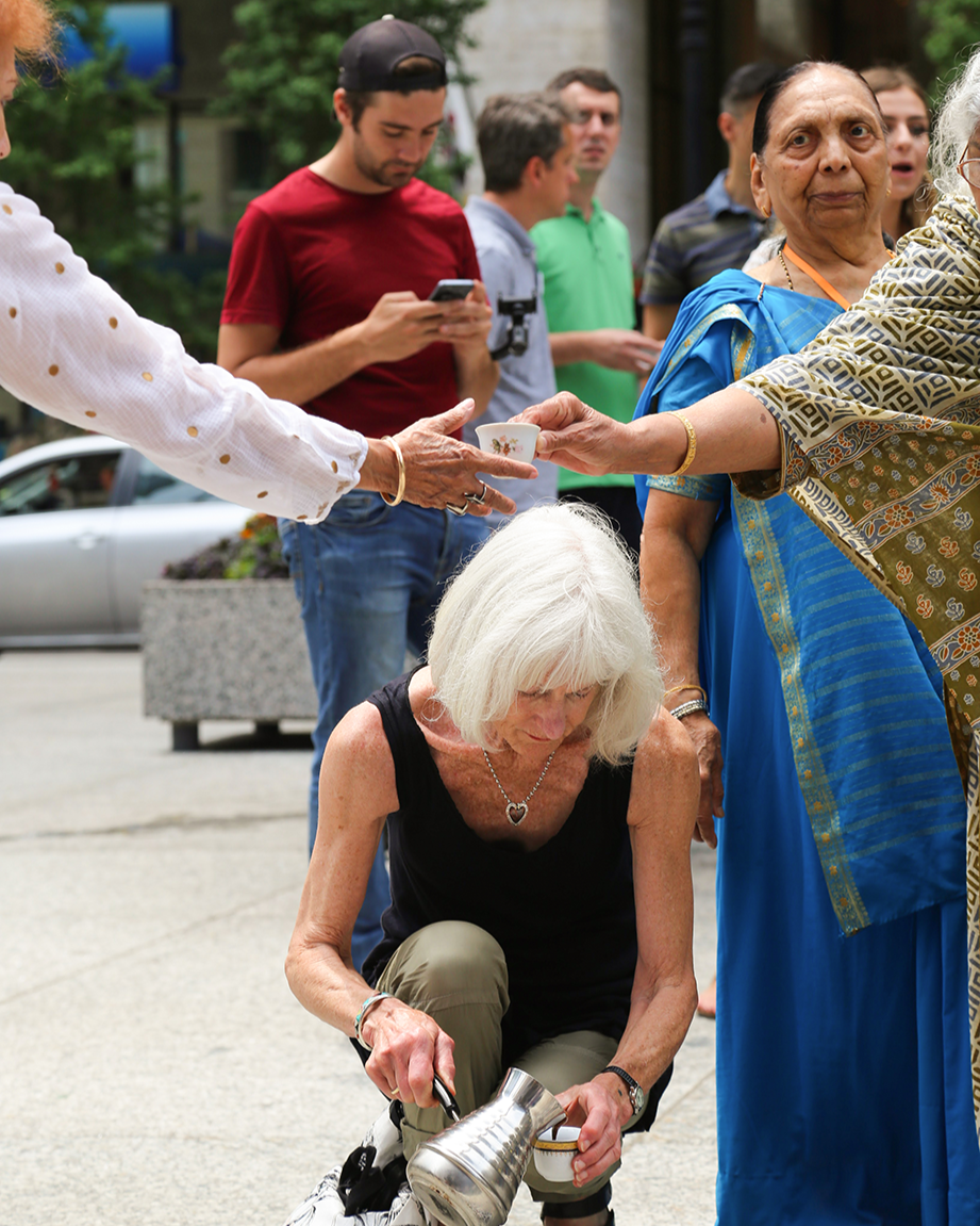 A elderly woman pouring traditional coffee in fildžan as part of the participatory monument što te nema