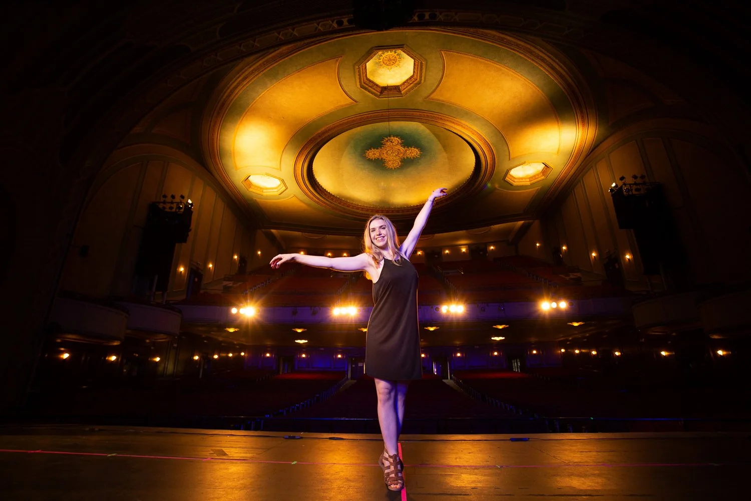 Victor NY senior pictures featuring high school female performing dance pose on theater stage