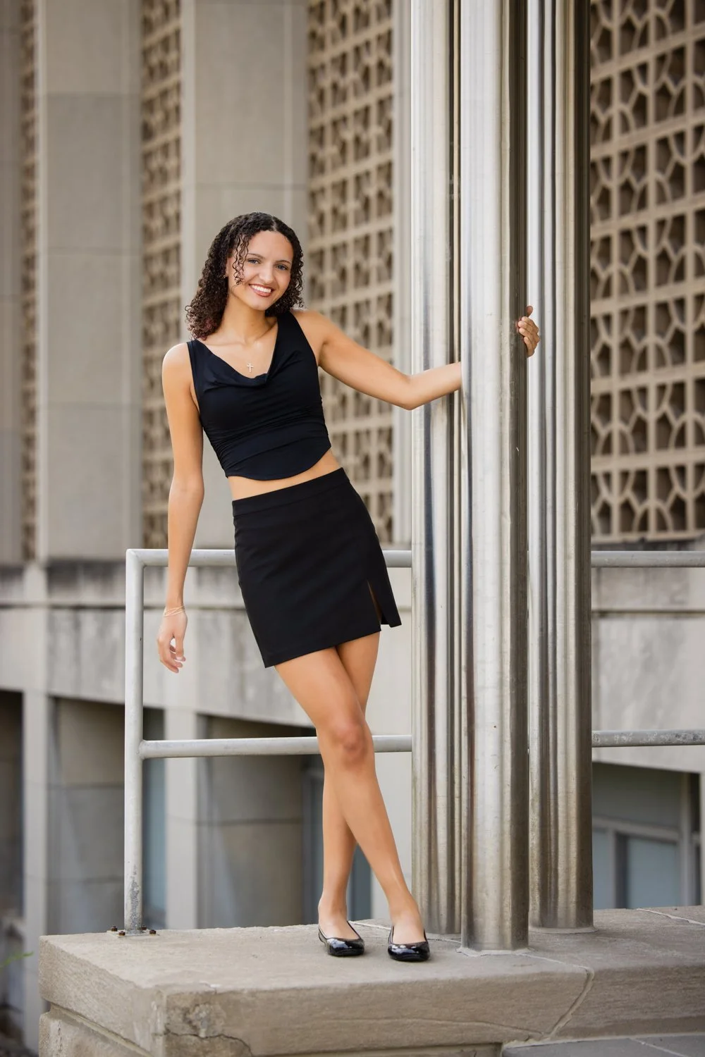 Williamsville NY senior pictures featuring high school senior posing by brick building on UB campus