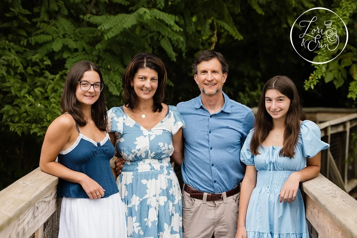 A family picture of a family with two high school age girls at Thomas Creek Boardwalk in Fairport
