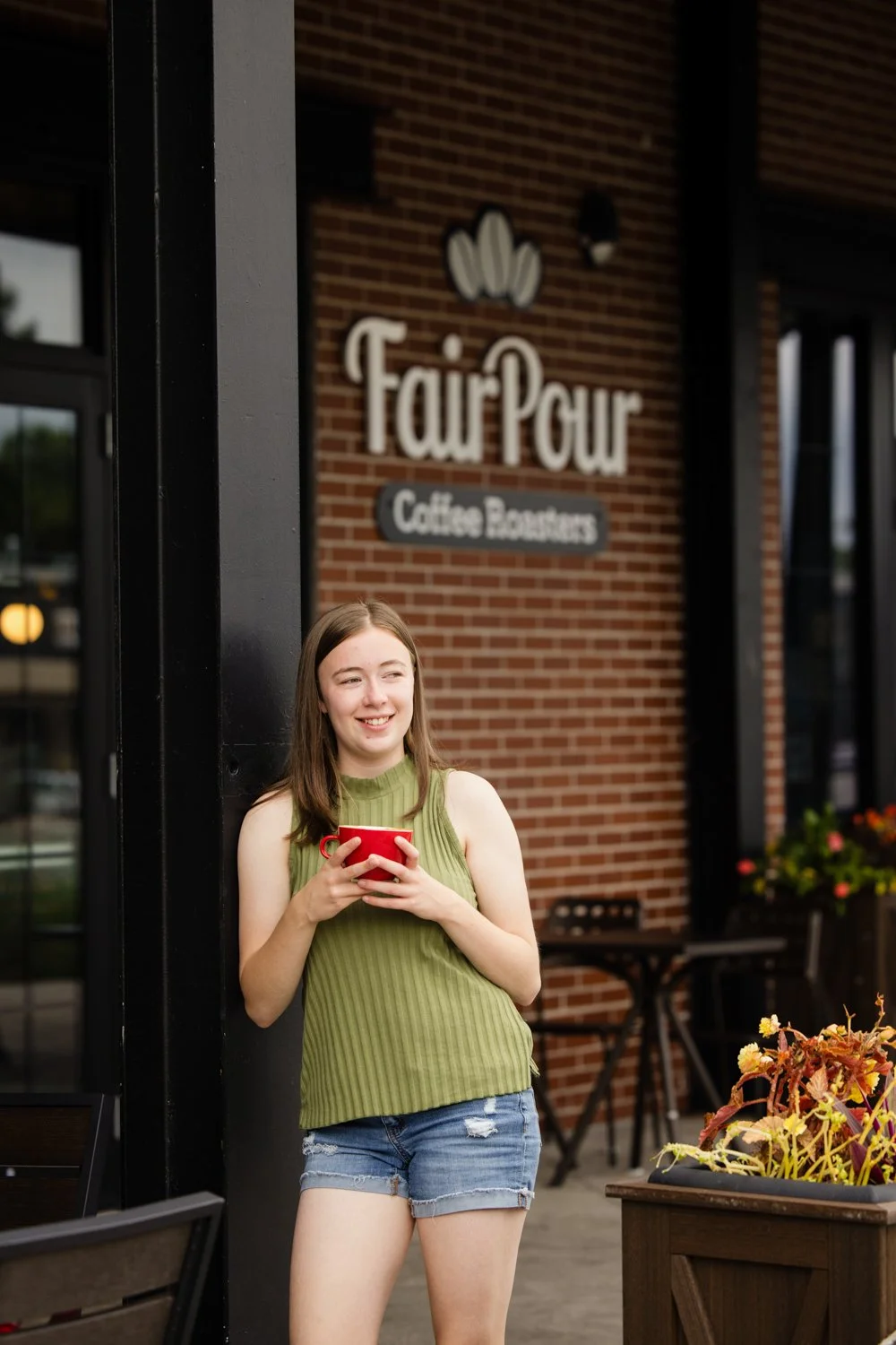 Senior photo session in Fairport NY at Fairpour Coffee capturing senior outside local café